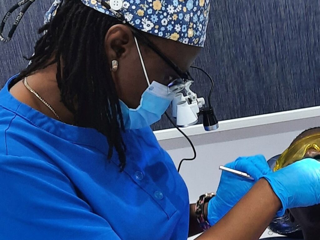 Dr Judith checking out a patient's teeth - Can Toothache Disappear?